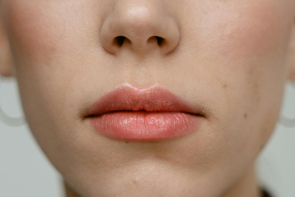 Detailed close-up of a person's healthy, naturally vibrant lips and clear, smooth skin, indicative of advanced topical skincare efficacy.