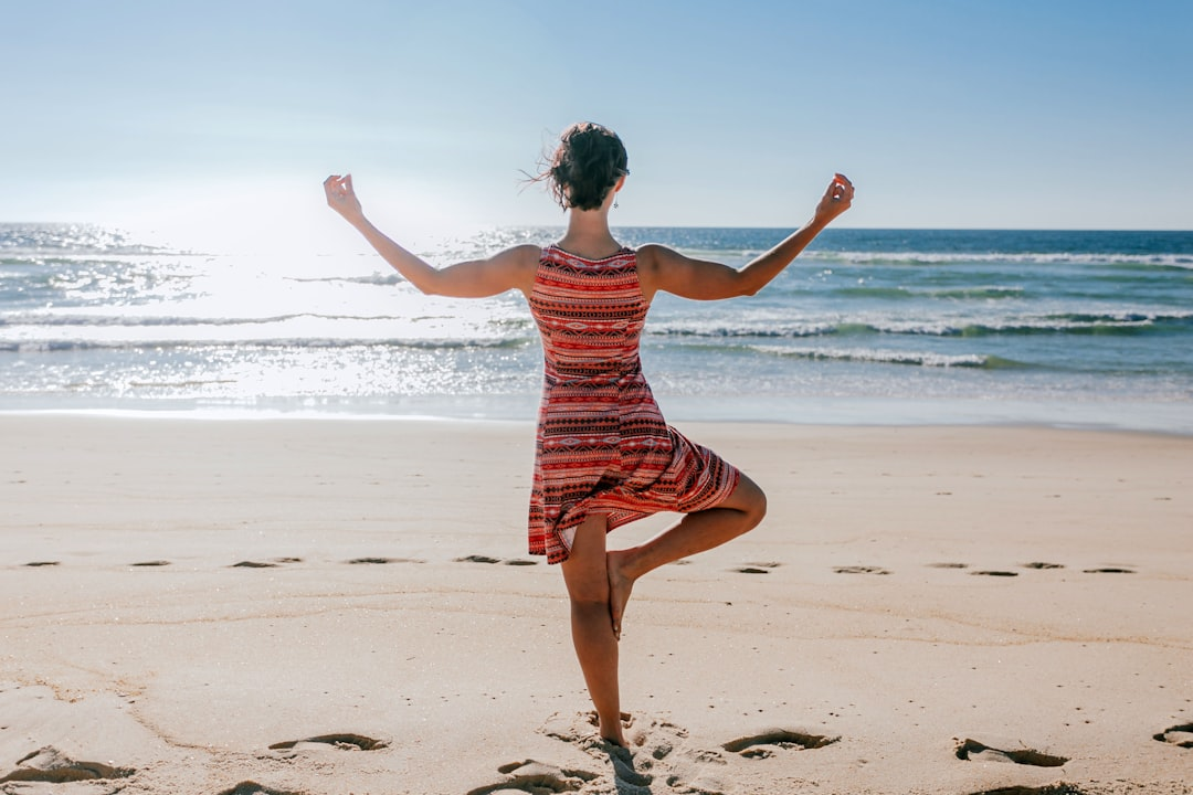 A serene hand gently mists a cooling, calming blue vapor onto subtle red fiery flares within a transparent human silhouette, symbolizing anti-inflammatory strategies leading to health and extended life.