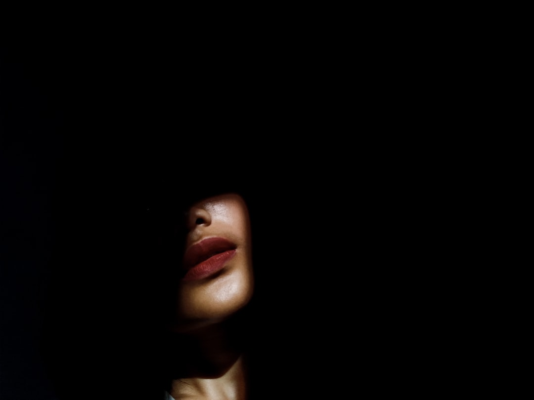 Multiple distinct beams of colored light (red, blue, and an invisible near-infrared glow) precisely targeting different areas of a human face and scalp, illustrating the specific applications of various light therapy wavelengths for skin and hair rejuvenation.