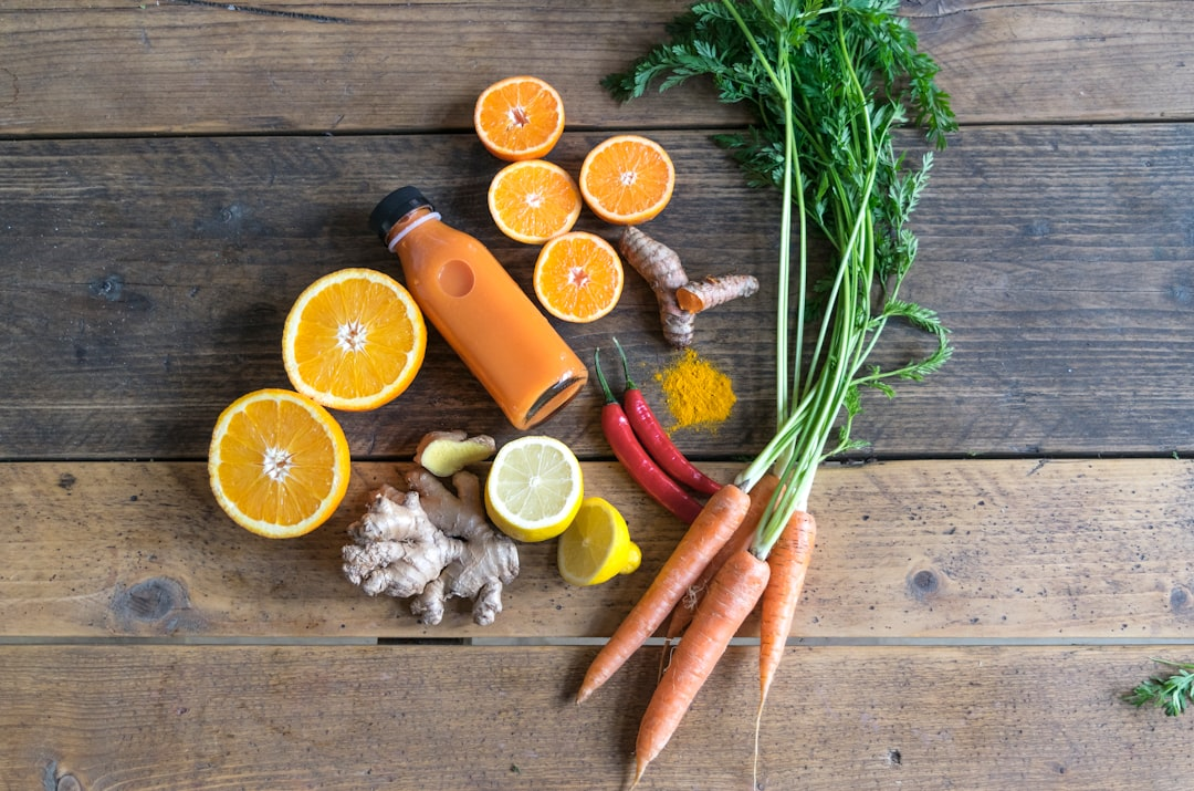 A close-up of hands thoughtfully arranging a vibrant, balanced selection of whole, anti-inflammatory foods—such as colorful fresh vegetables, a piece of salmon, and walnuts—on a rustic wooden surface, symbolizing intelligent nourishment and rebalancing.