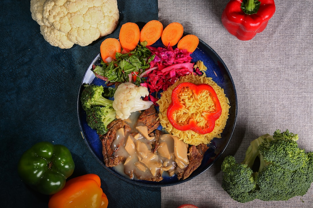 A visually striking still life of high-quality, low-glycemic foods such as vibrant broccoli, creamy avocado, lean protein, and healthy nuts, arranged to form a stable base, with a subtle, perfectly flat line representing steady blood sugar flowing across the composition, symbolizing metabolic control.