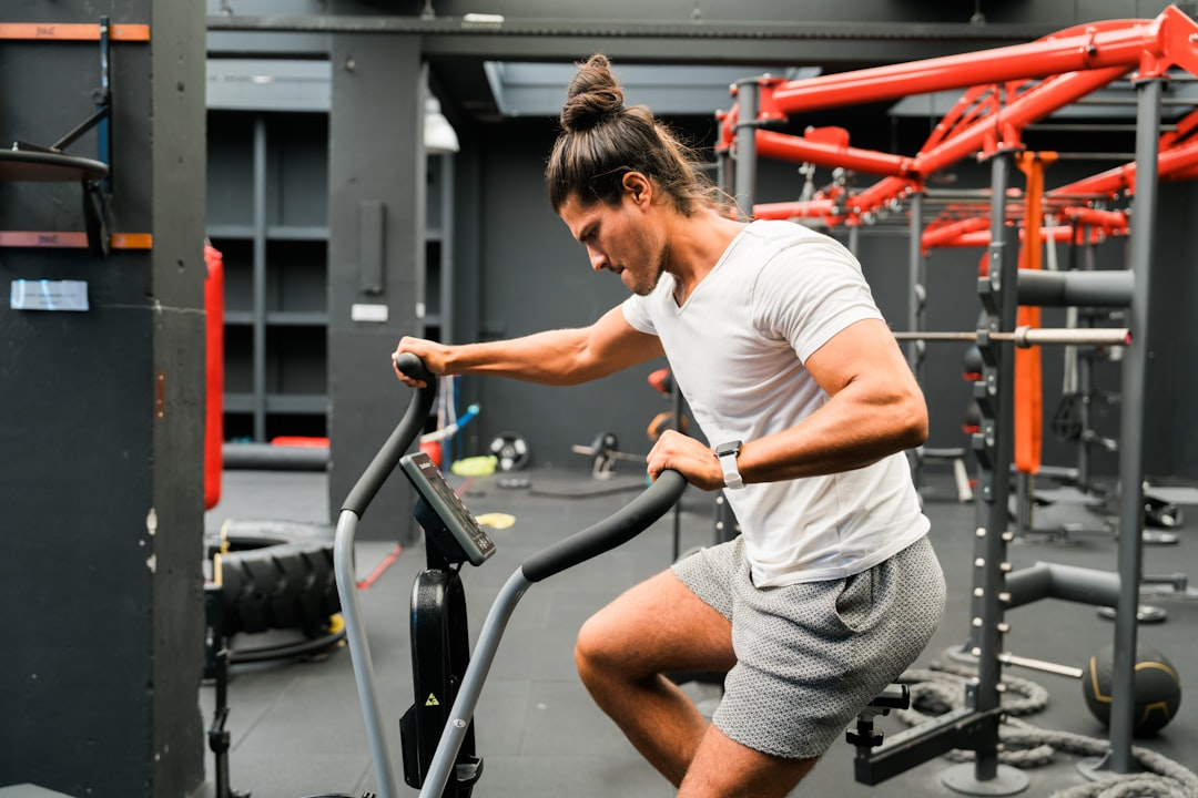 A powerful athlete mid-action, surrounded by a dynamic visual montage of diverse fitness activities like a blurred running track, flying kettlebells, and battle ropes, symbolizing varied metabolic workout protocols.