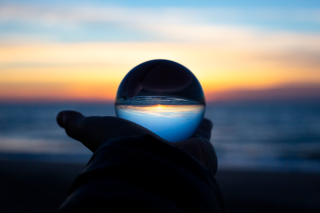 A futuristic, sleek medical device, reminiscent of a telescope, casts a soft red light onto a human eye, which is surrounded by glowing, intricate data streams and abstract patterns, symbolizing the expanding frontiers of research and revolutionary new therapies for ocular health.