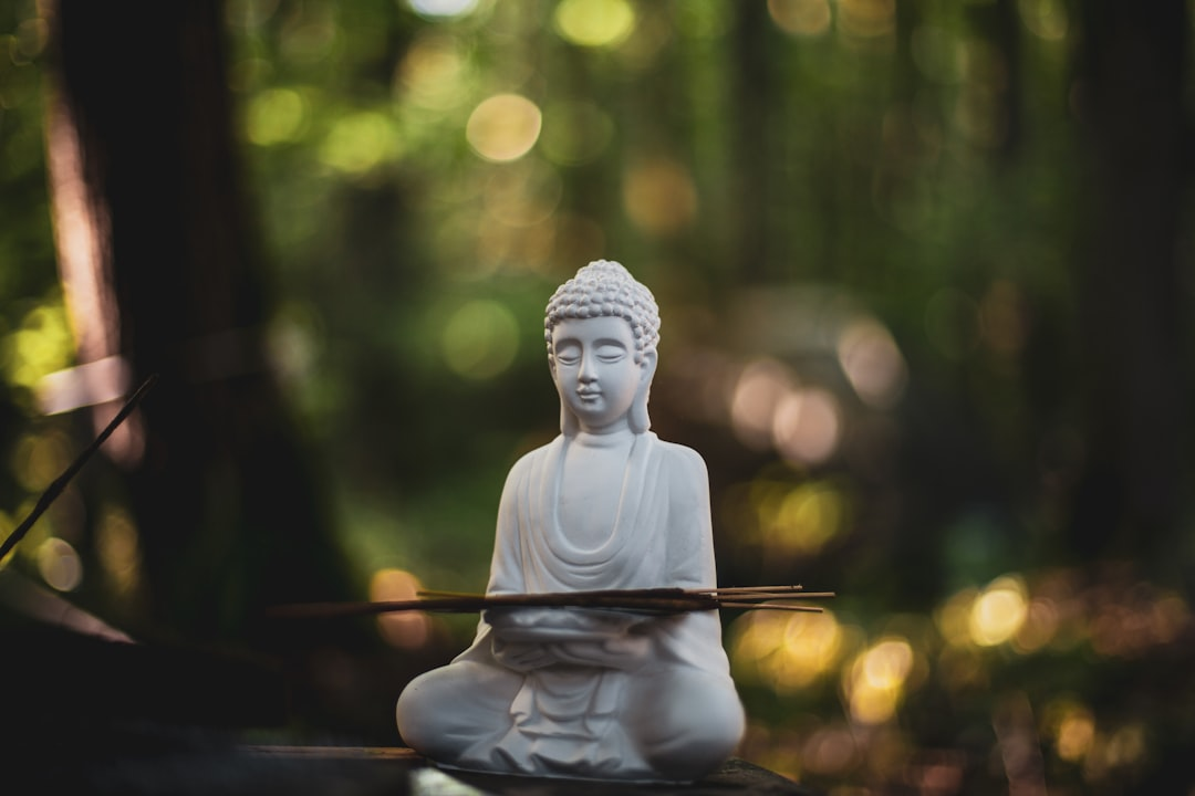 A person meditating in a serene setting, surrounded by subtle, glowing data visualizations like brainwaves and heart rate patterns, representing real-time biofeedback deepening self-awareness.