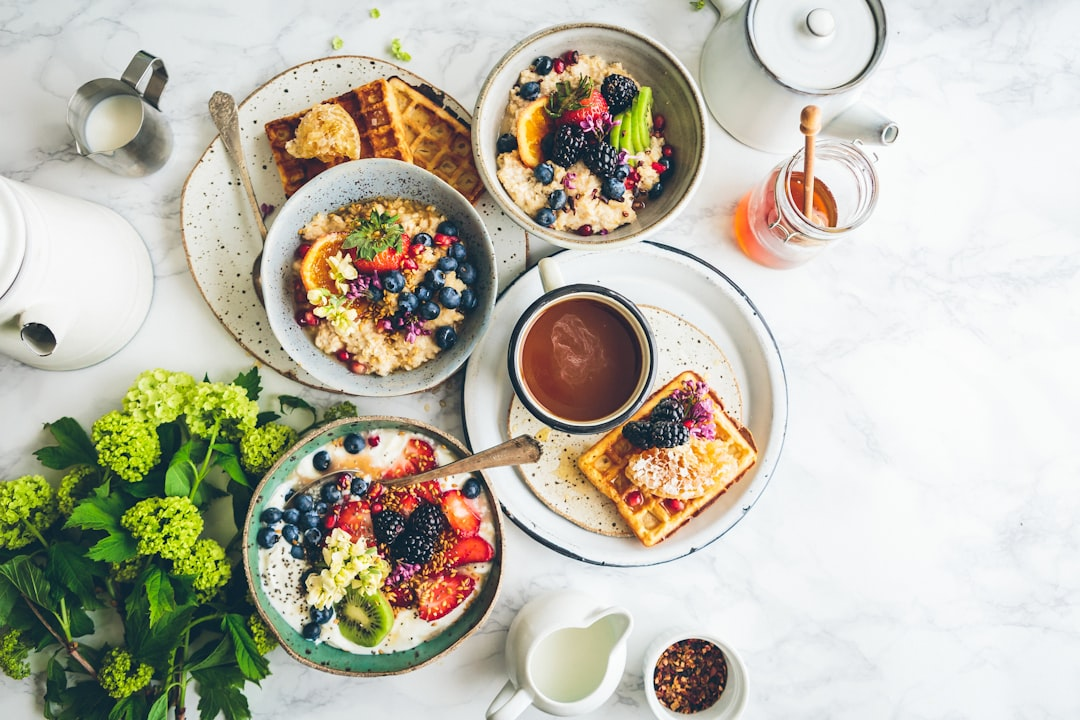 A beautifully composed still life of diverse, high-quality protein sources—like grilled salmon, lean grass-fed steak, and vibrant pastured eggs—arranged on a natural wooden surface, with subtle golden light emanating from the food, visually transforming into intricately glowing cellular structures, symbolizing their role in advanced nutritional support and cellular repair for longevity.