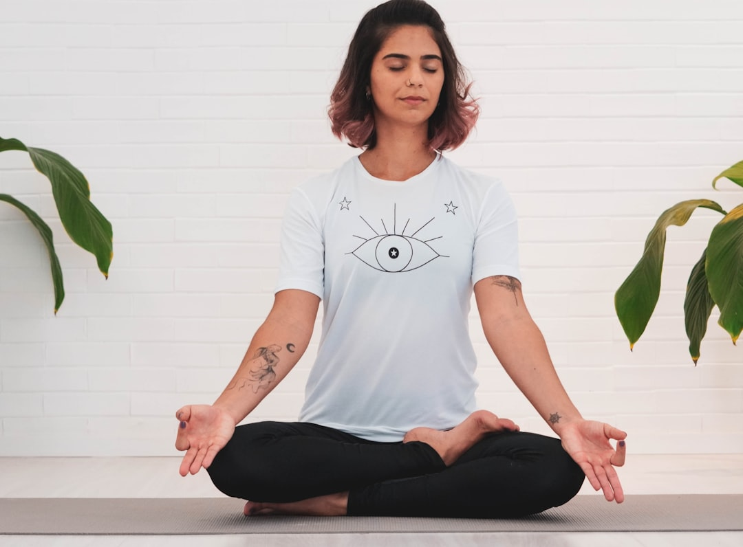 A peaceful human figure meditating amidst soft natural light, with a visible, harmonious glow radiating from their gut connected by subtle threads of light to their serene mind, illustrating how calm lifestyle choices heal and strengthen the gut-brain axis against stress.