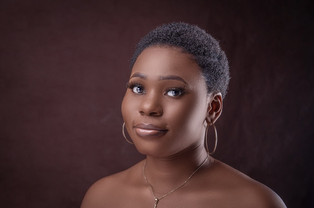Close-up of a diverse individual's radiant skin and lustrous hair, subtly enhanced by soft, targeted beams of light emanating from elegant, futuristic light therapy and energy devices, symbolizing advanced rejuvenation.