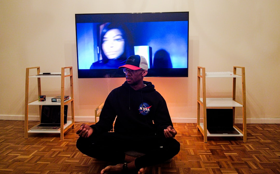 A serene person meditating, their head surrounded by subtle, harmonious light waves gently pulsing and aligning, visually depicting brainwave entrainment through meditation.