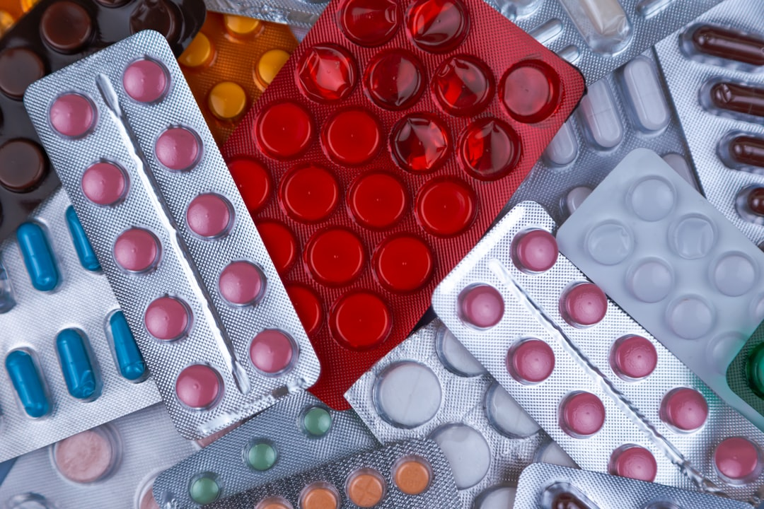 A futuristic, glowing supplement capsule filled with distinct, targeted microscopic biological elements (specific bacterial strains, prebiotic fibers, and postbiotic compounds), sharply focused against a blurred, generic probiotic pill in the background, illustrating advanced gut health strategies.