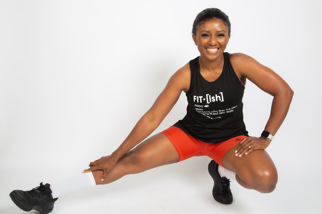 A person with a radiant, healthy glow, performing a mindful strength exercise in a bright, clean space, surrounded by artfully arranged fresh, vibrant whole foods like avocados, leafy greens, and wild-caught fish, symbolizing holistic hormonal well-being.