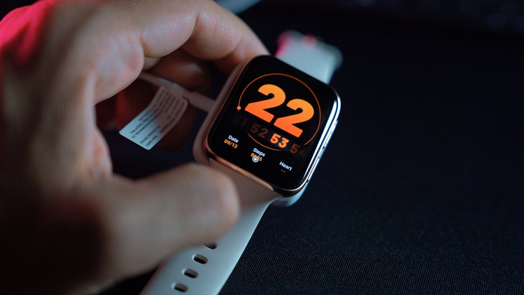 A person practicing breathwork in a calm, minimalist space, with subtle, glowing digital overlays showing real-time heart rate variability (HRV) data and a discreetly placed timer on a mobile device, symbolizing the integration of technology and mindful tools for enhanced self-regulation.