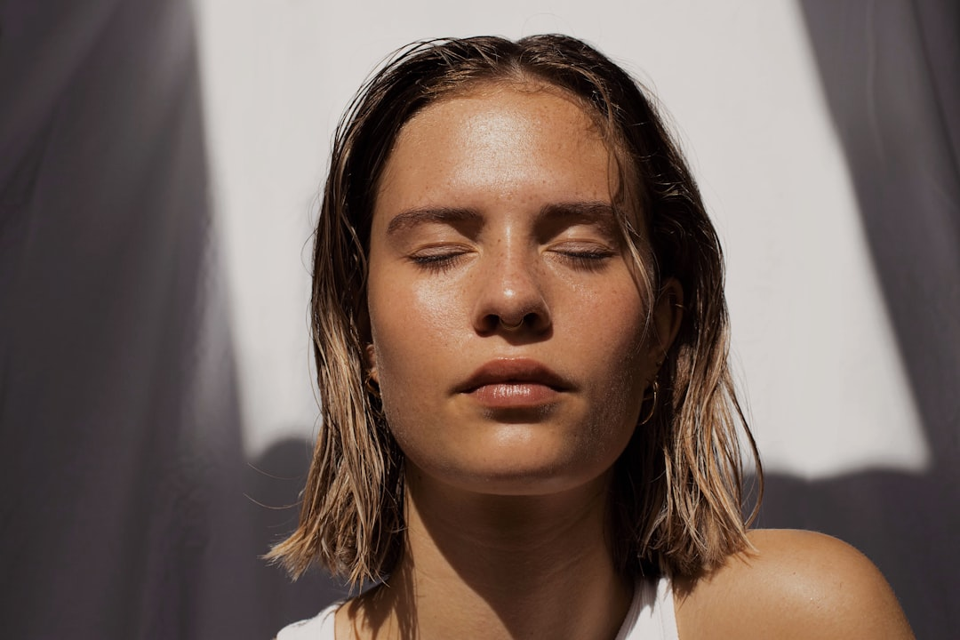 A radiant, bio-engineered serum droplet interacts with the surface of human skin, sending intricate, glowing light trails deep into a stylized cellular matrix where vibrant, interconnected skin cells and collagen fibers visibly pulsate with renewed activity and regeneration.