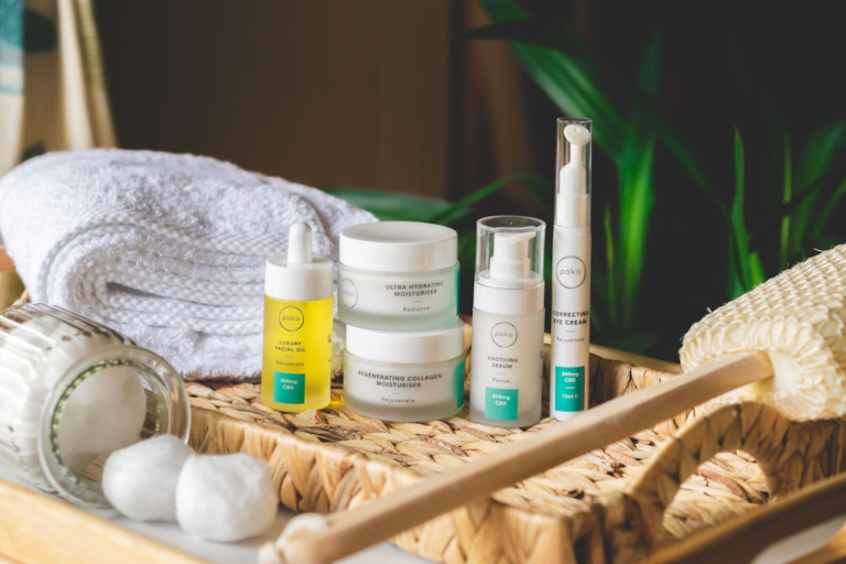 A calming collection of Poko skincare, featuring a correcting eye cream, hydrating moisturizers, and facial oil, is beautifully displayed on a natural woven tray with a soft towel, emphasizing wellness and eye health.